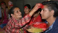 दशैँमा टीका ग्रहण गर्दै एक युवक