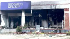 ছবিতে একটি ভাঙ্গাচোড়া ভবন, বেক্সিমকো হেলথের সাইনবোর্ড দেখা যাচ্ছে