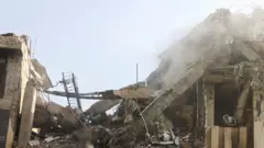 Fumaça sobe de um prédio danificado após ataques israelenses em Teerã