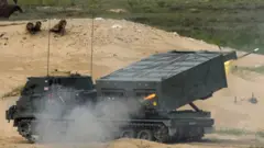 M270 Multiple Launch Rocket System (MLRS) firing a rocket on a military exercise
