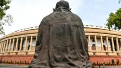 ভারতের জাতীয় সংসদ ভবন । সামনে গান্ধীমূর্তি