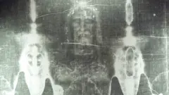A detail from the Turin Shroud, showing the head of a bearded man