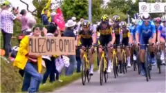 The spectator can be seen holding a sign