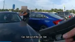 Footage of police with guns drawn