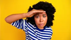 Woman looks embarrassed and hiding face