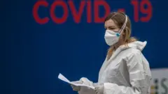 A masked health worker stands near a Covid-19 testing centre in Prague, Czech Republic on 17 September