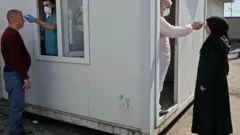 امرأة ورجل يخضعان للفحص بسبب فيروس كورونا