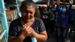 People pray outside the Penitenciaria del Litoral prison