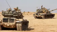 துருக்கியை சமாளிக்க சிரியாவுடன் சமரசம் செய்யும் குர்து இன கிளர்ச்சியாளர்கள்