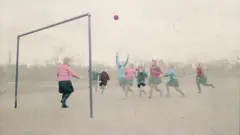 A group of girls playing football