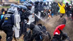 Police officers spray activists during a protest against the expansion of a German coal mine in Luetzerath