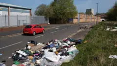 Fly tipping rubbish on road