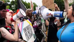 Pro-choice and anti-abortion activists with megaphones outside of the US Supreme Court as they wait for the court to hand down its decision on whether to overturn Roe v Wade