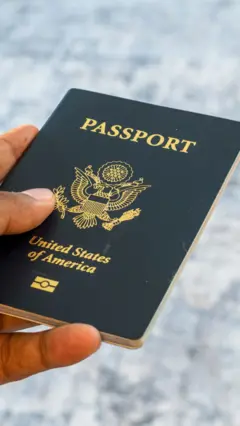 A hand holding US passport