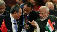 O primeiro-ministro da China, Li Qiang, conversa com o primeiro-ministro da Índia, Narendra Modi, durante uma sessão plenária da cúpula dos Brics no Rio de Janeiro, em 7 de julho de 2025