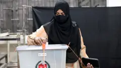 मतदान गर्दै एक महिला