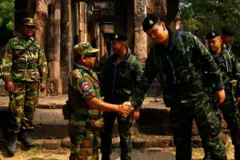 A Cambodian soldier (2nd L) shakes hands with a Thai soldier (2nd R) at the disputed ancient Khmer temple Prasat Ta Muen Thom, or Prasat Ta Moan Thom in Khmer, on the Cambodian-Thai border in Oddar Meanchey province on March 26, 2025. (Photo by TANG CHHIN Sothy / AFP) (Photo by TANG CHHIN SOTHY/AFP via Getty Images)
