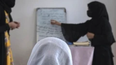 An Afghan woman watching two women give a lesson