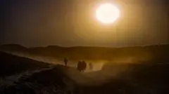 Afghans walk through the drought-hit countryside in October 2023