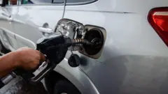 Fuel attendant dey sell fuel for customer for one filling station for Yaba, Lagos, Nigeria, on Saturday, July 29, 2023.