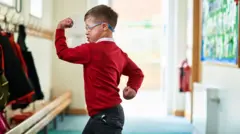 Uma criança de óculos em uma escola.