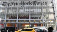 In this file photo a man holds his smartphone in front of the New York Times building on September 6, 2018 in New York