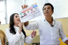 Salvador Nasralla sostiene la papeleta con su voto, con una cruz debajo de su foto, ya su lado también sostiene la boleta su esposa, Iroska Elvir.