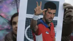 A supporter of Serbian tennis player Novak Djokovic holds a photo during a protest of support in Belgrade, Serbia, 08 January 2022.