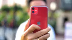 Hombre sostiene iPhone 11