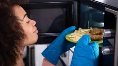 Woman reheating food.