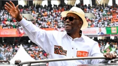 President Ouattara waving at a crowd