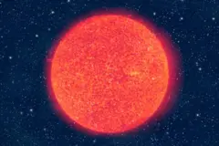 Uma imagem de uma esfera brilhante, de tom laranja intenso, no espaço, com muitas estrelas distantes ao fundo escuro