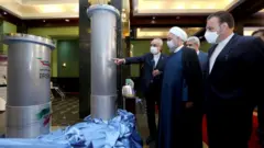 Iranian President Hassan Rouhani (2nd left) is shown nuclear technology in Tehran on 10 April 2021