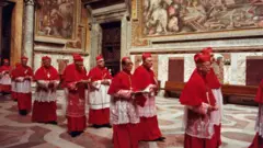 Cardinals file into the Sistine Chapel to take part in the papal Conclave to elect a successor to Pope John Paul II in 2005.