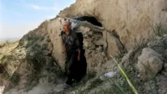 This photo taken on May 24, 2021 shows shepherd Zhu Keming, hailed as a hero in China for rescuing six ultramarathon runners when extreme weather hit the area leaving at least 20 dead, showing the cave dwelling where he sheltered the stricken athletes near the city of Baiyin, in China's northwestern Gansu province.