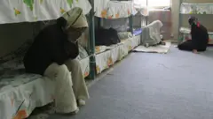 Iranian women inmates sit at their cell in the infamous Evin jail