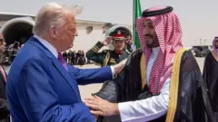 US President Donald Trump (L) shake hand wit Saudi Crown Prince Mohammed bin Salman Al Saud (R) as e arrive Malik Khalid Airport. Trump wear suit while di Prince wear white cloth wit black overall