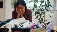 Woman wey dey arrage cloth