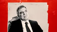 11. Cumhurbaşkanı Abdullah Gül. Arkasında bir çalışma masası ve Türk bayrağı görülüyor. 