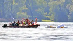 Carabinieri and fire brigade officers take part in the search and rescue operation in Lake Maggiore after a tourist boat capsized near Lisanza (Varese), northern Italy, 29 May 2023