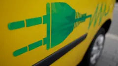 A power plug symbol is seen on an electric car