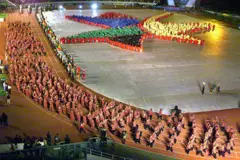The South African team walks into the Johannesburg stadium while hundreds of children form the logo of the games, during the opening ceremony of the 7th All African Games