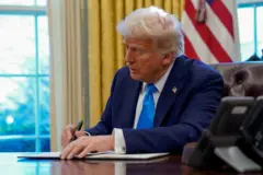 U.S. President Donald Trump signs a document in the Oval Office at the White House in Washington, U.S. February 4, 2025.