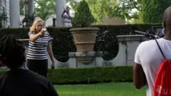 Patricia McCloskey pointing a weapon at protesters outside her home in St Louis in June