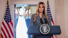 Melania at a podium 