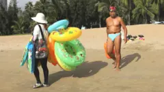 People at a beach in Sanya