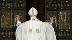 Pope Francis opens the Holy Door to mark opening of the Catholic Holy Year, or Jubilee, in St. Peter's basilica, at the Vatican, December 8, 2015.