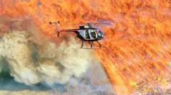 A helicopter flies a forest fire.