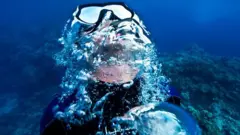 Mergulhador respirando debaixo d'água