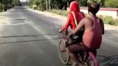 girl and her father on a bycle